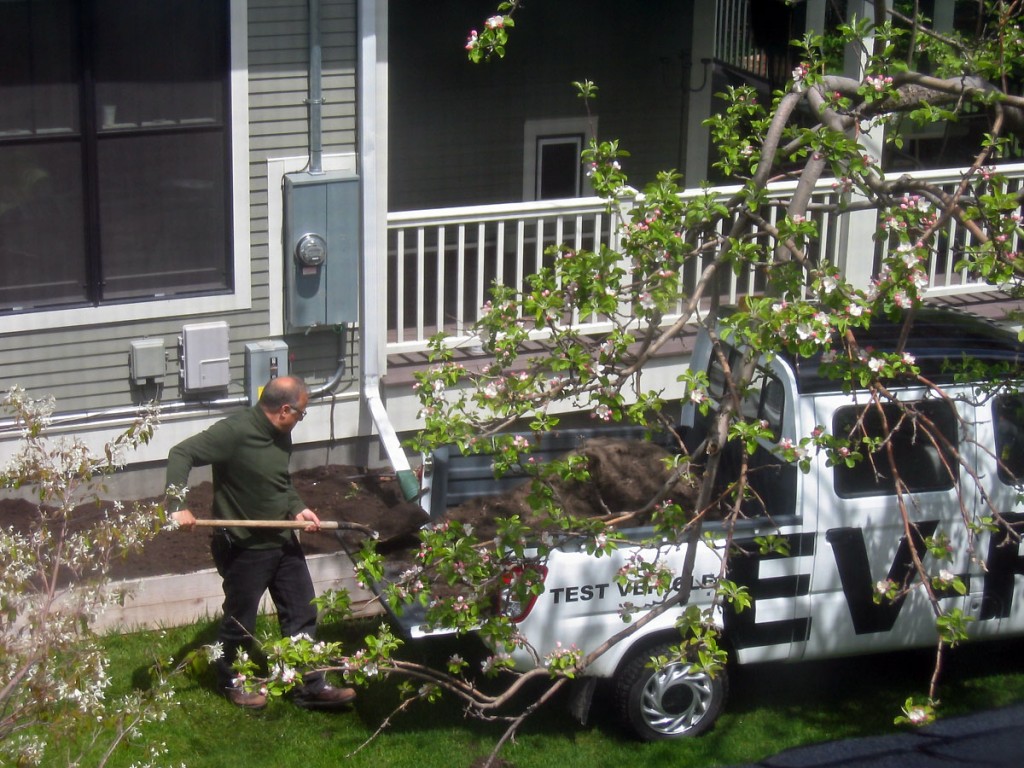 Neighbor with his electric wheelbarrow.  The short lived eco garden.  I love how the ice sliding off the solar panels destroyed the rainwater collection that was supposed to supply this garden.  Also wondering if the hail-destroyed panels ever made more energy than was put into them.